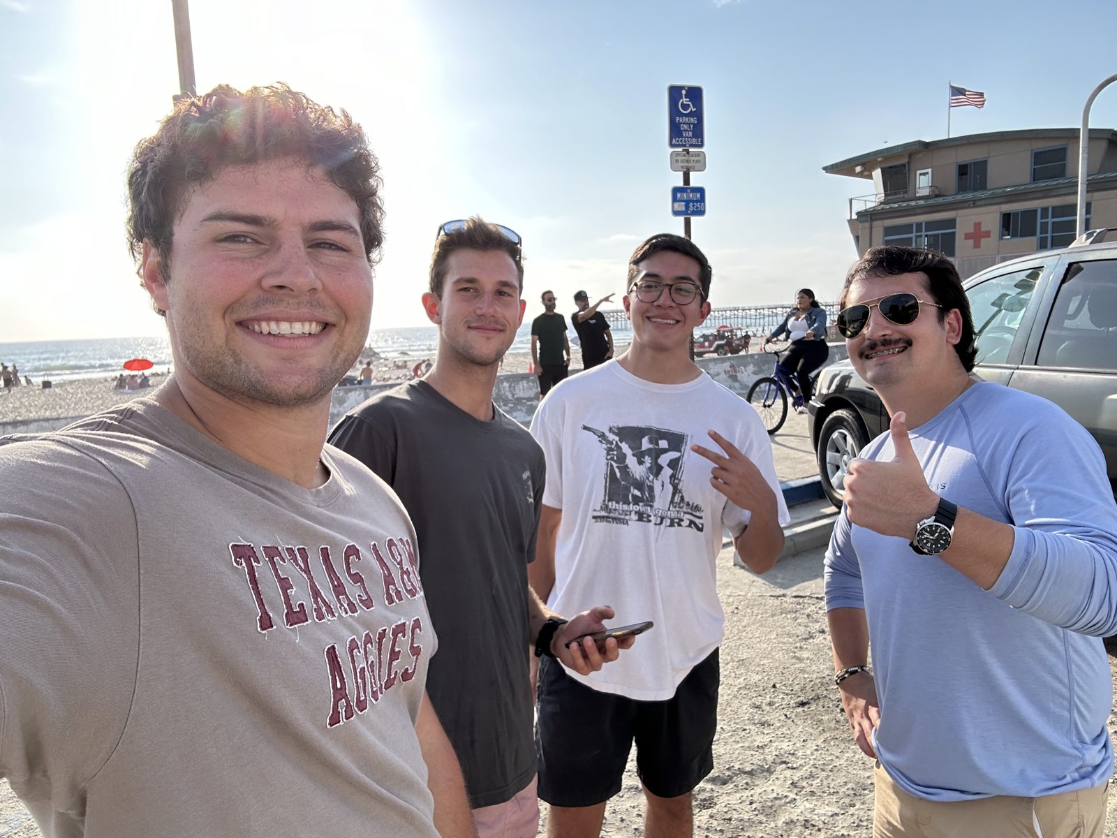 Selfie on a beach boardwalk with three friends