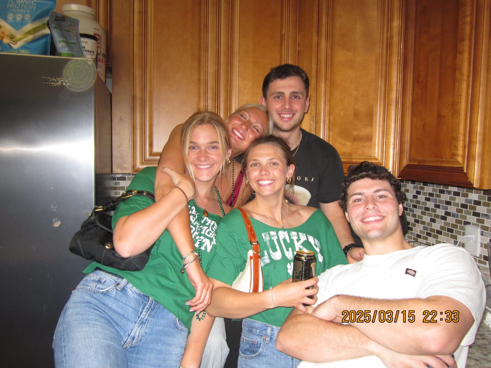 Friends crowded together in a kitchen