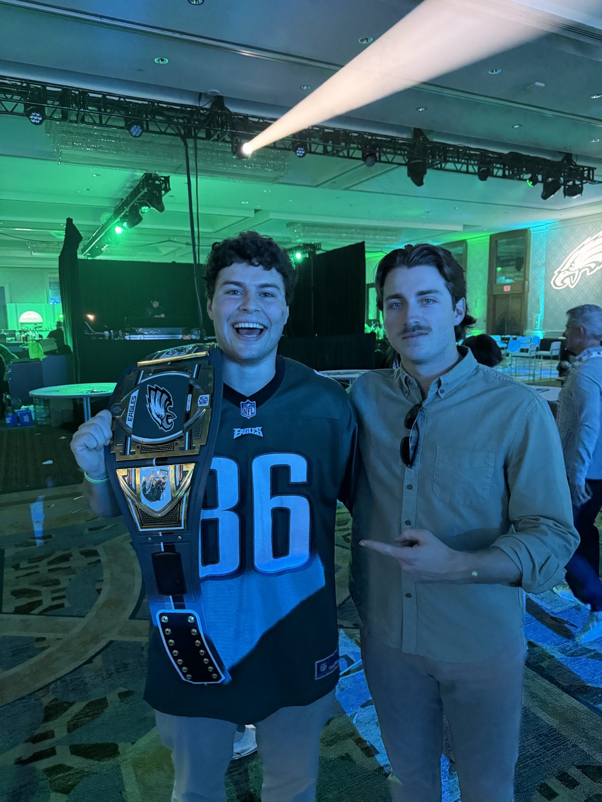 Holding a championship belt at an event